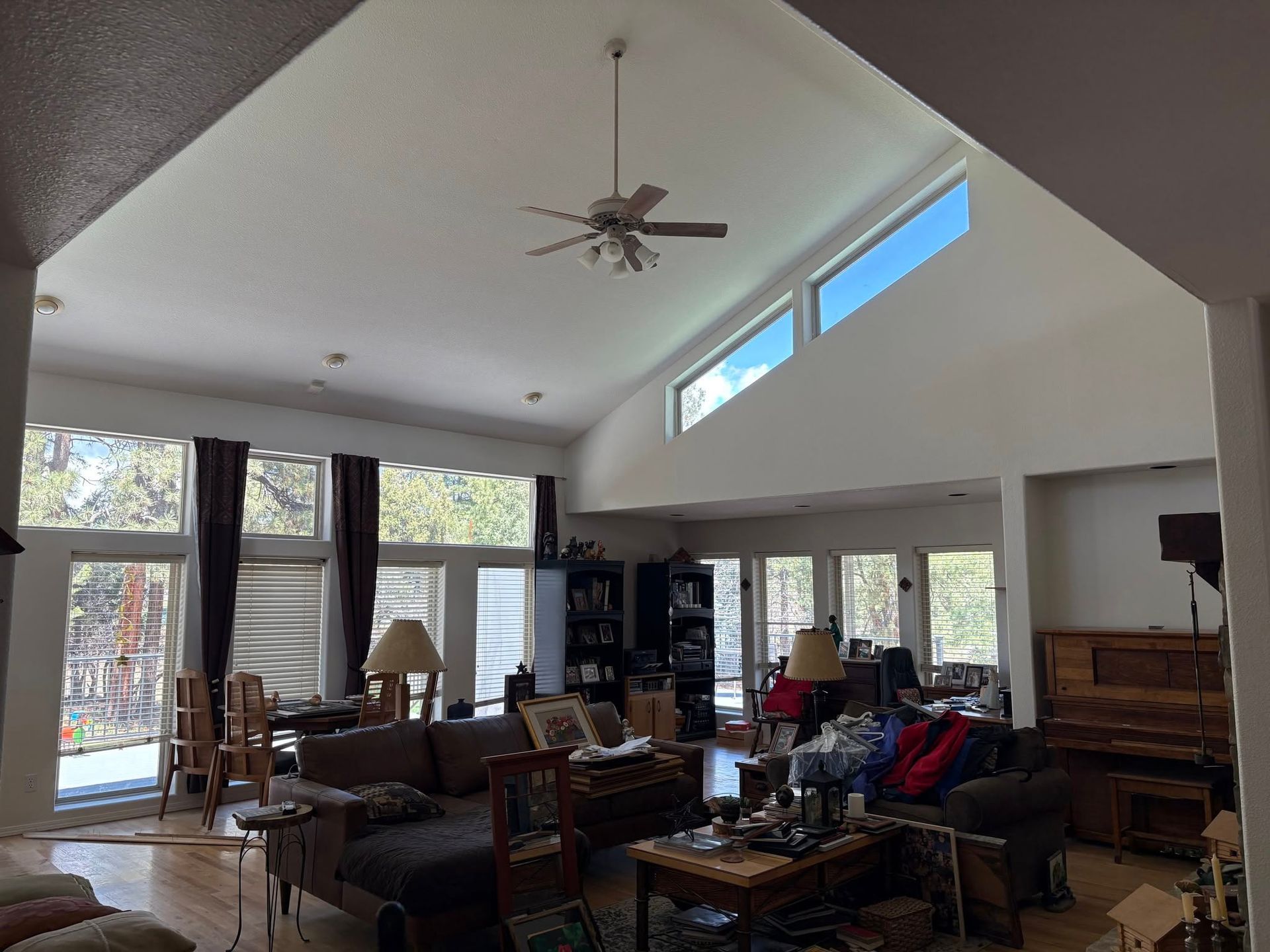 An empty room with a kitchen and a window. The room has fresh painted walls and ceilings