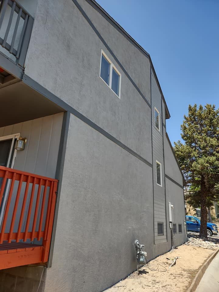 A freshly painted building with a balcony on the side of it