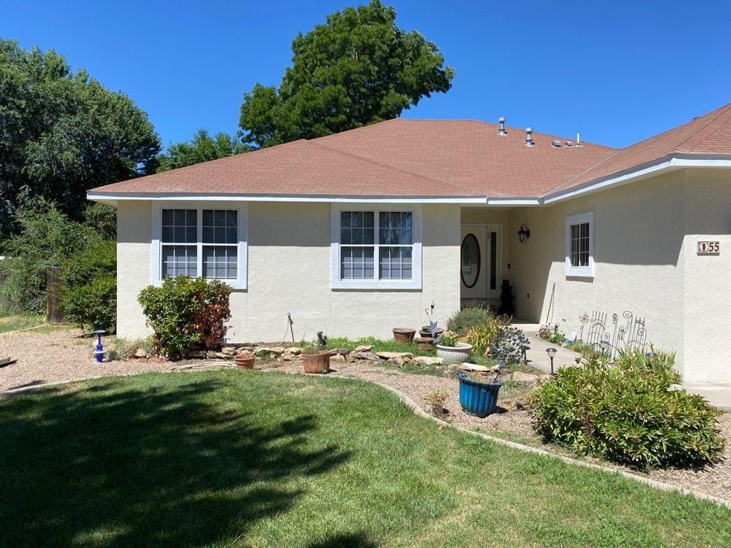 A white house with a brown roof and a lot of windows, Residential exterior painting services
