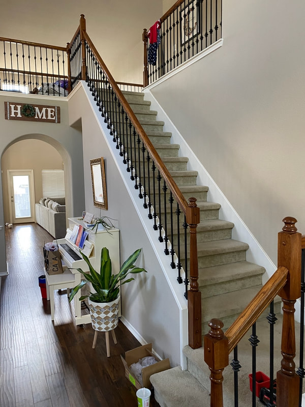 A staircase in a house with a sign that says home