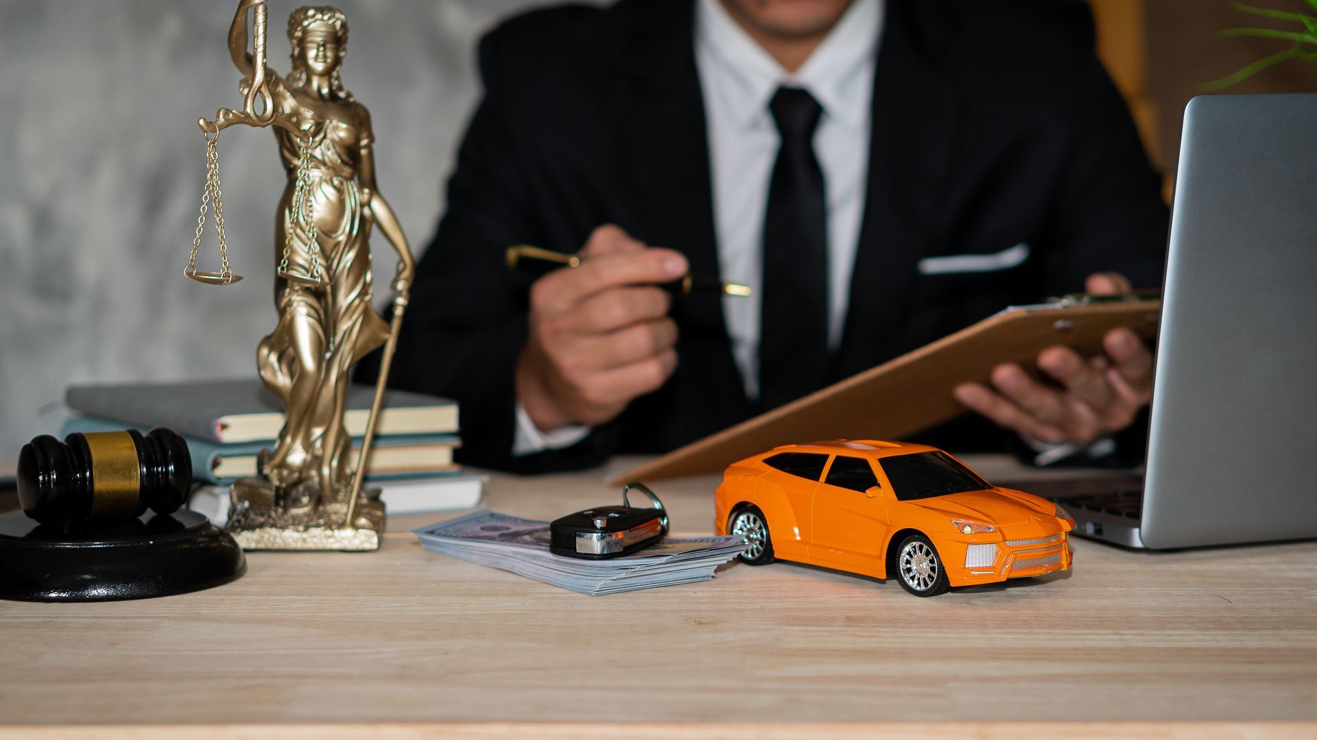 A man and woman sit beside a car, representing Cramer & Peavy, Car Accident Attorney in Forsyth  County, GA.