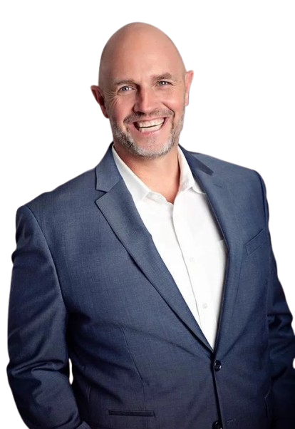 A man in a blue suit and white shirt is smiling.