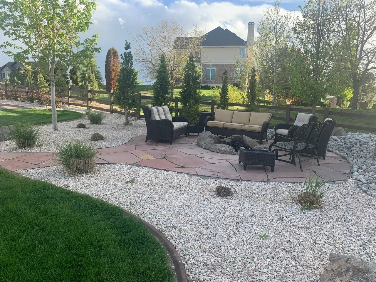 There is a fire pit in the middle of the backyard.