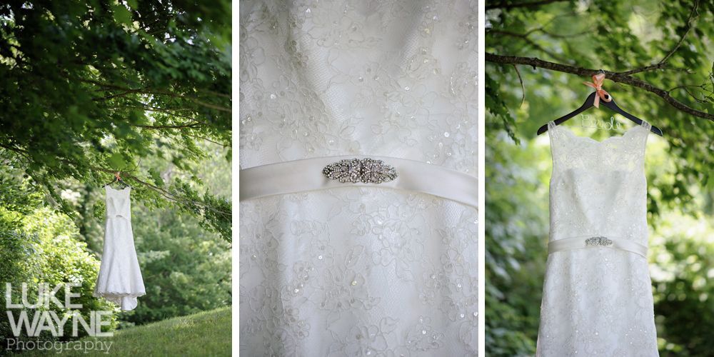 Wedding dress hanging from a tree branch in a garden setting. Close-up detail of the dress.