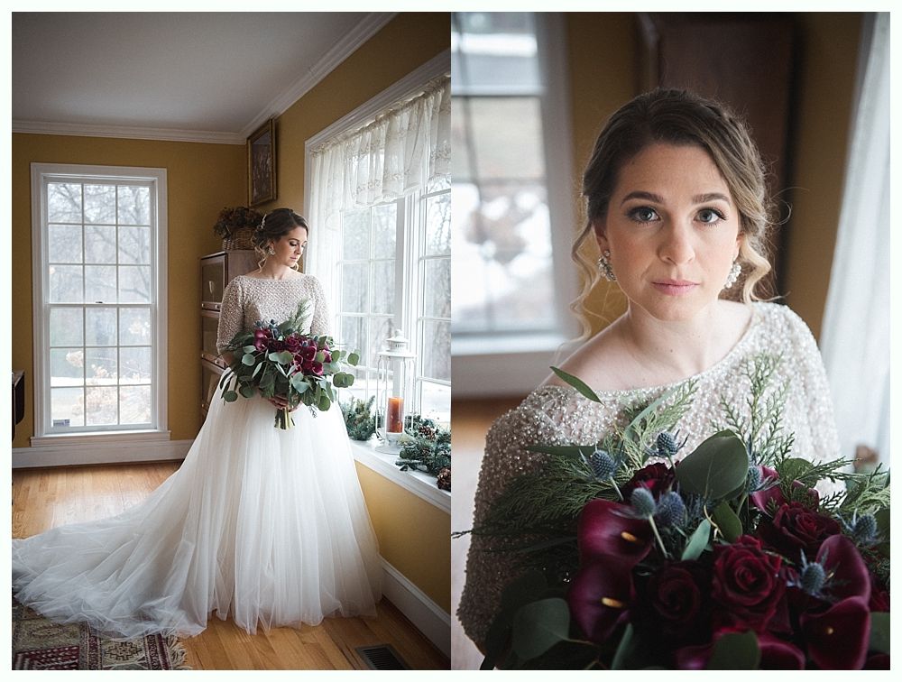 Bride in a white wedding dress smiles, holding a bouquet. A veil flows in the wind under a weeping willow.