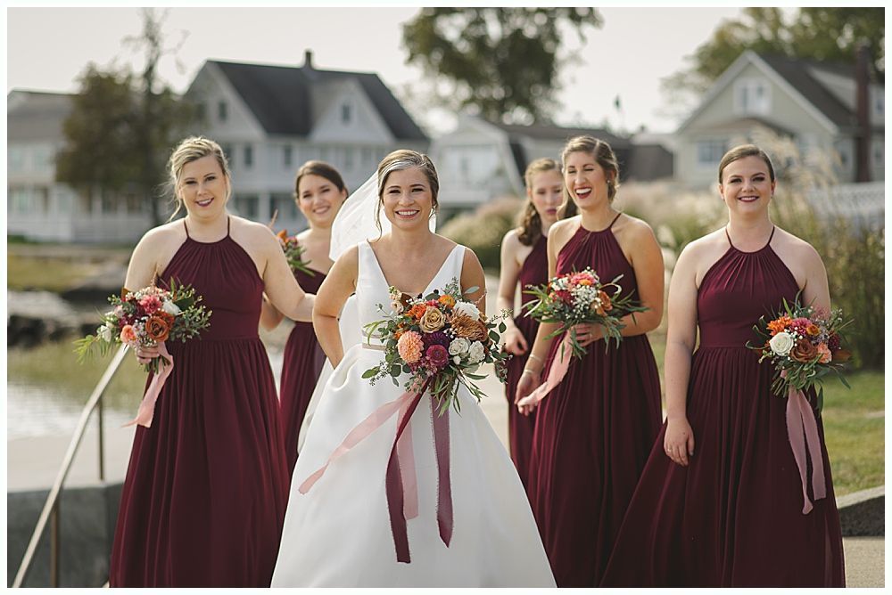 Wedding décor: seating chart, floral garlands, welcome sign, bar with disco ball lighting.