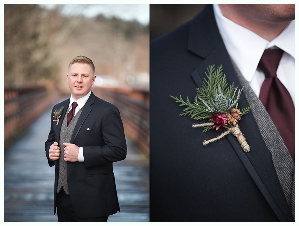 Wooden wedding arch decorated with greenery and red and white flowers, outdoors.