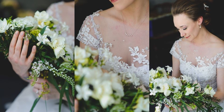 Bride in white gown holding bouquet, posed outdoors. Sunlight streams through trees.