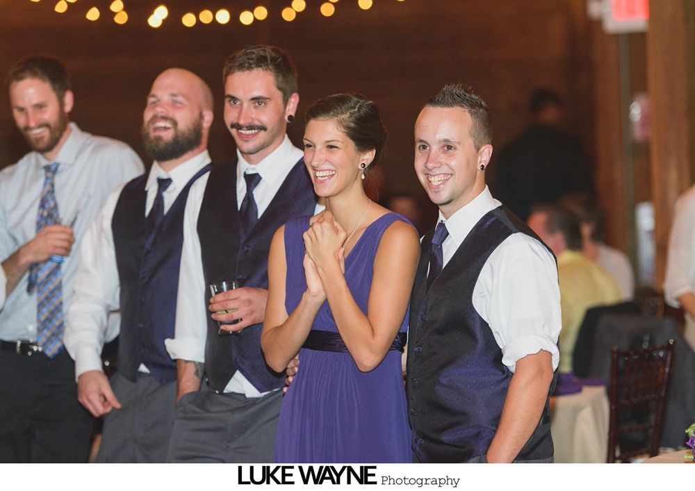 Wedding reception with dancing; bride in a white gown and guests in colorful dresses on a dance floor.