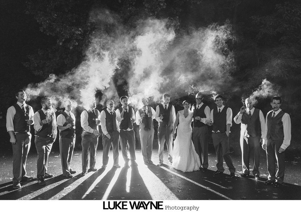 Wedding reception with dancing; bride in a white gown and guests in colorful dresses on a dance floor.