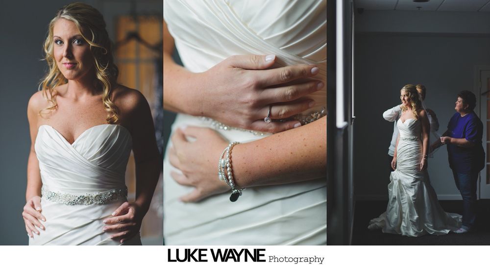Bride in a white wedding dress; hands on waist, receiving assistance.