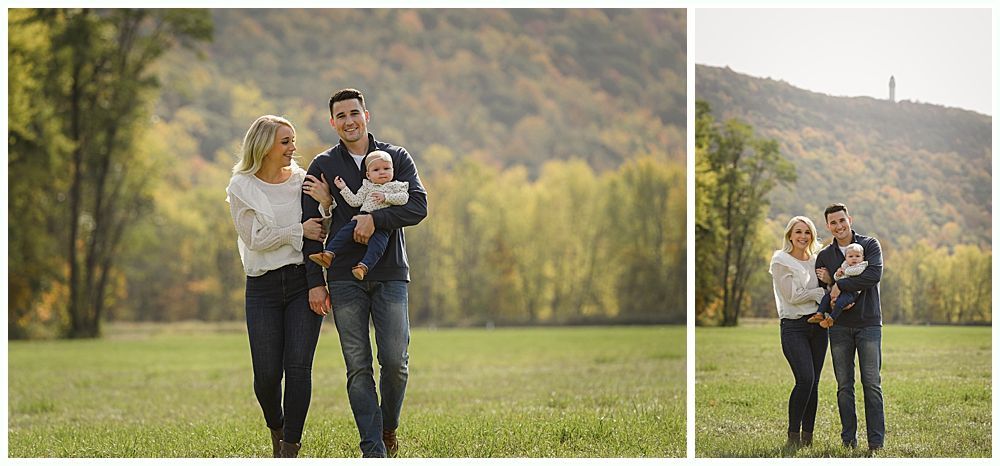 A family walks together on a grassy field with trees and a mountain in the background.