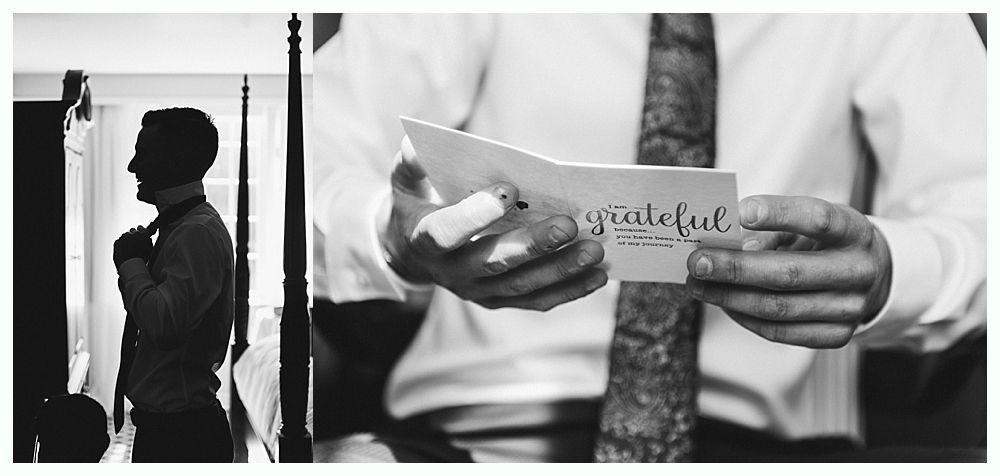 Man adjusting tie, holding a card that says