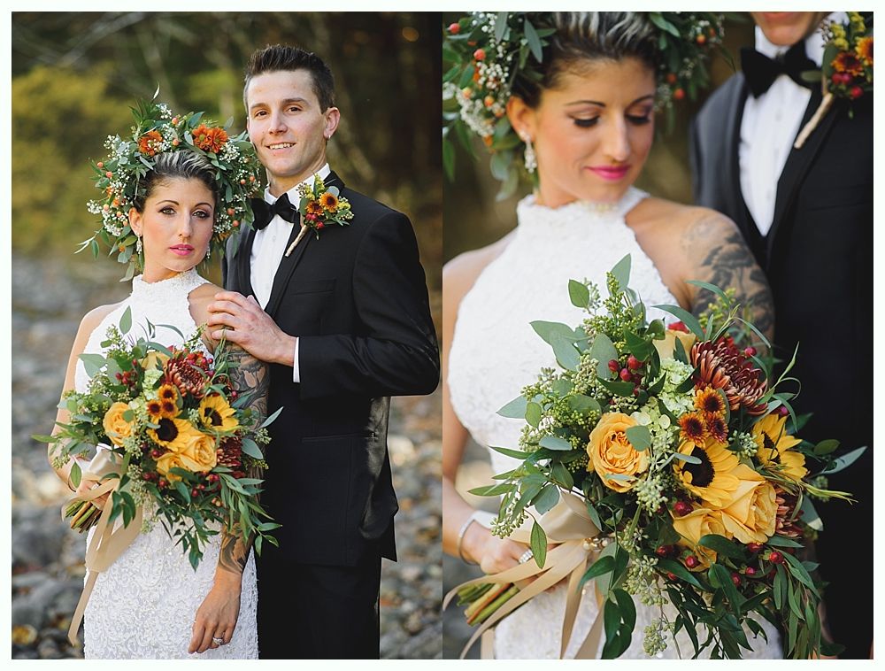 Bride and groom posing. Bride wears white halter dress, flower crown, holds bouquet. Groom wears black tuxedo, boutonniere. Outdoors.