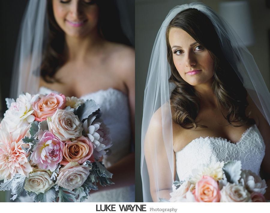 Bride holding a bouquet of pink and peach flowers, wearing a strapless white dress and veil.
