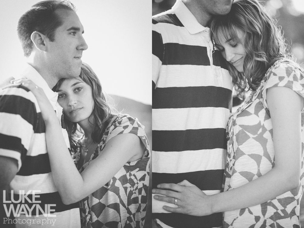 Couple embracing, one wearing striped shirt, other patterned top, both appear affectionate.
