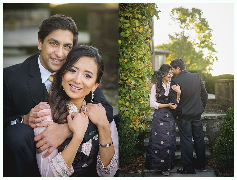 Couple poses for engagement photos in a garden setting.