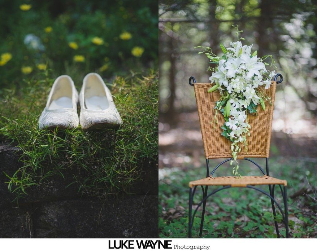 Pair of white shoes on grass; floral arrangement on a chair in a forest.