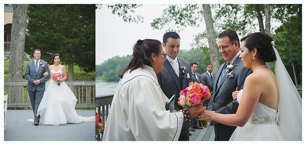 Wedding ceremony with bride escorted by father, and exchanging flowers with groom, near water.