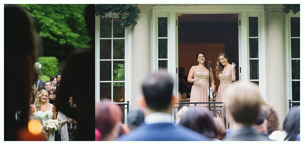 Bride walking toward the altar as two women sing from a balcony.