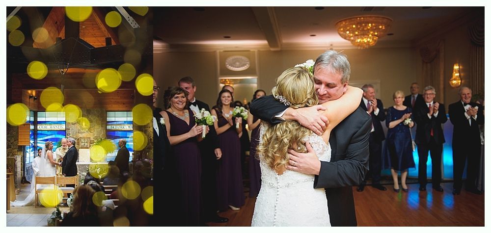 Bride and groom embrace on a dance floor, as guests clap in a wedding reception hall.