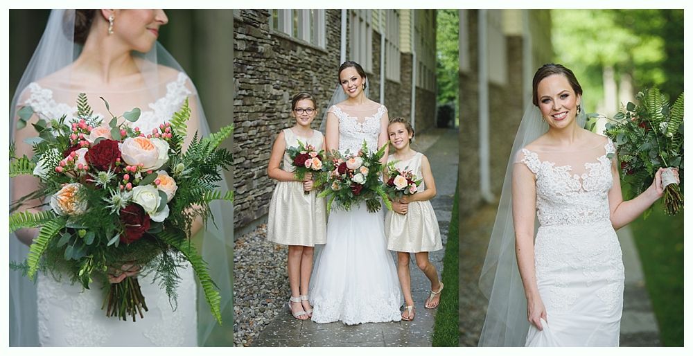 Bride and bridesmaids in wedding attire with bouquets, posed outside near stone wall.