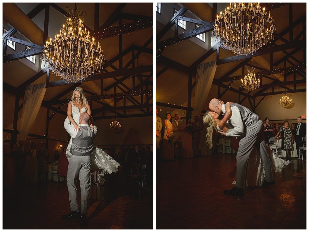Wedding dance: Groom lifting bride in a ballroom, kissing. Elegant chandeliers and guests in background.