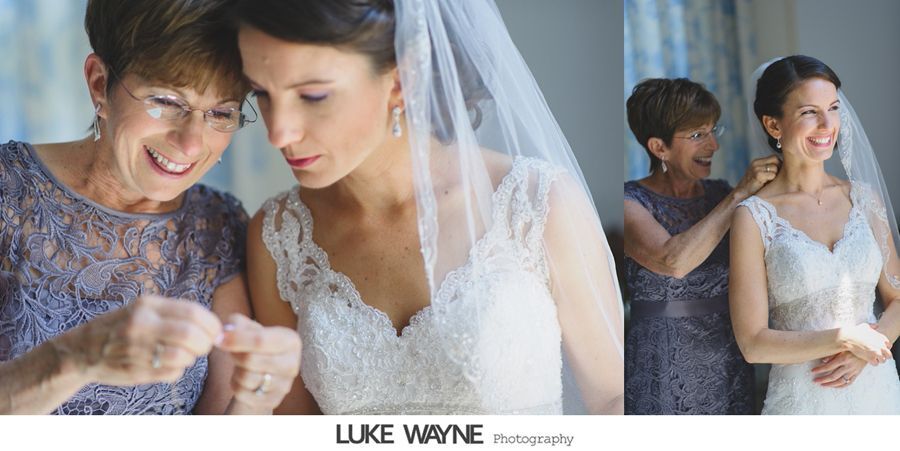 Bride with her mother before the wedding, mother putting on a necklace.
