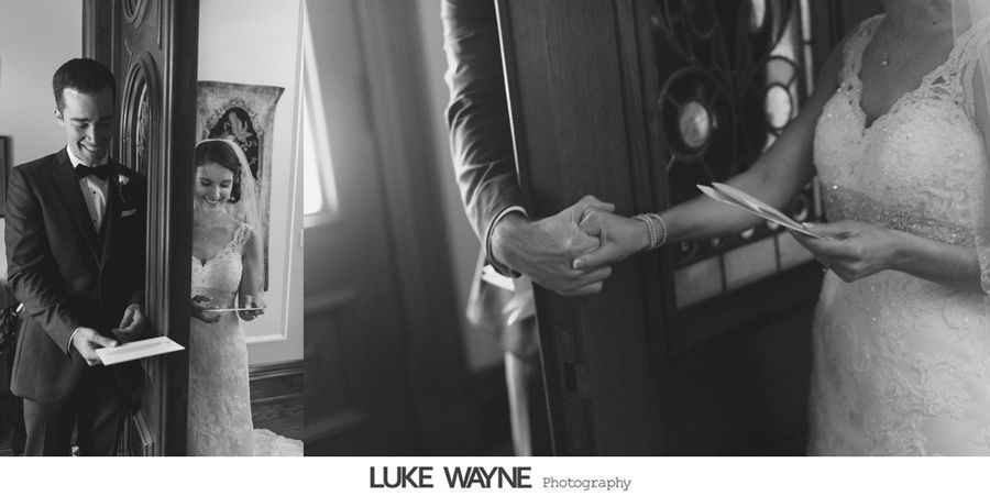 A bride and groom hold hands while reading letters before the wedding ceremony.