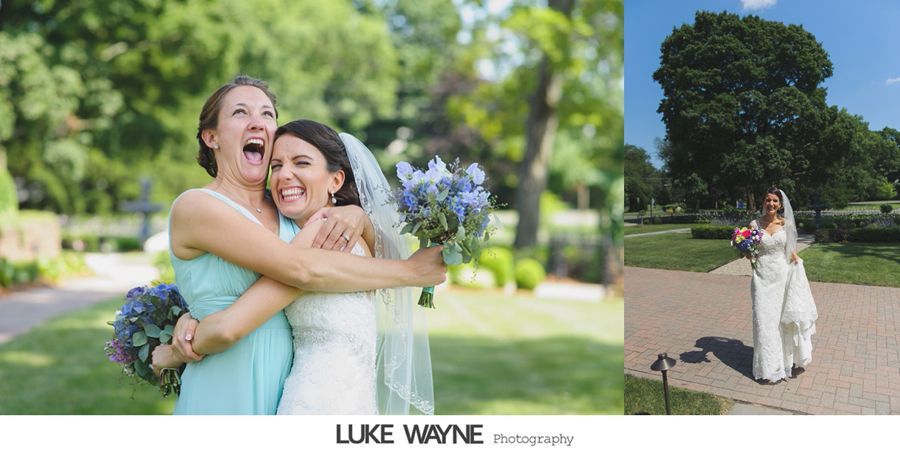 Bride hugs bridesmaid, both joyful, holding bouquets, in a garden.