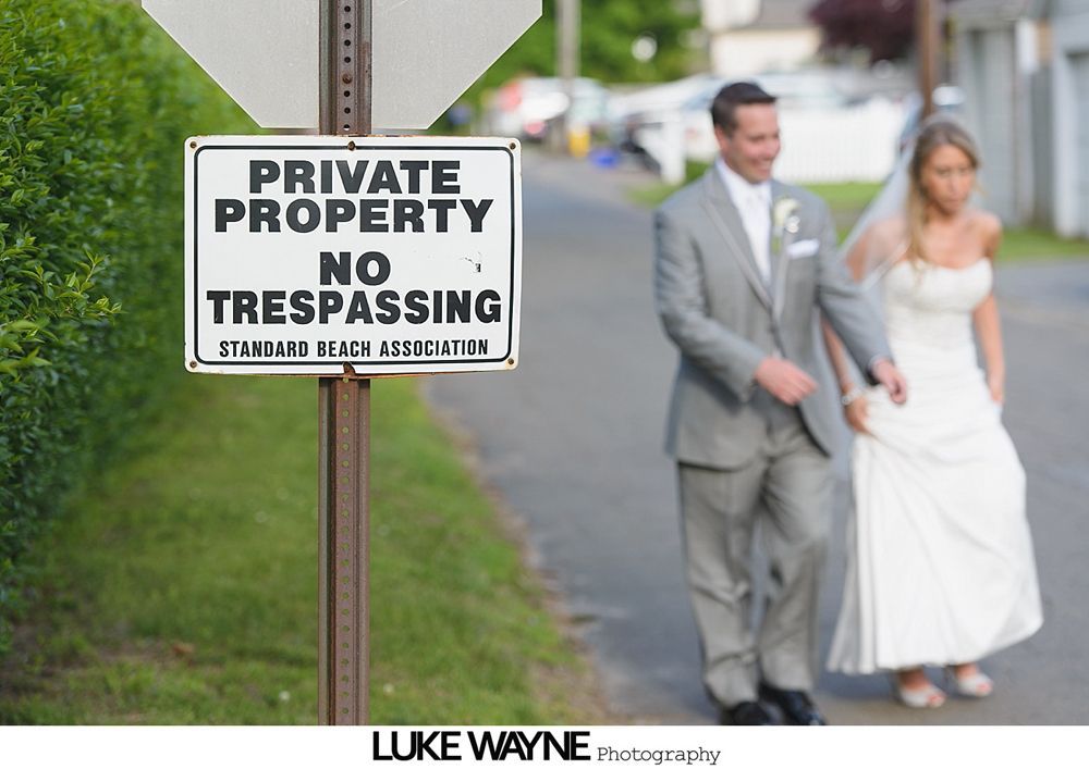Wedding couple walks on a street, passing a 