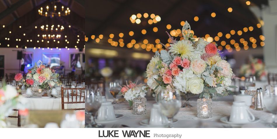 Wedding reception table with floral centerpieces, soft lighting, and string lights.