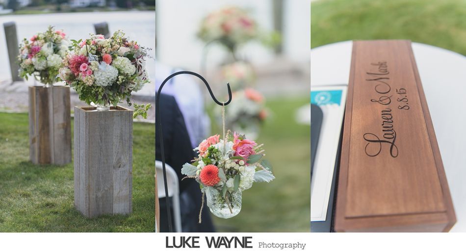 Wedding decor: floral arrangements on wooden pedestals, hanging flower baskets, engraved wooden box.