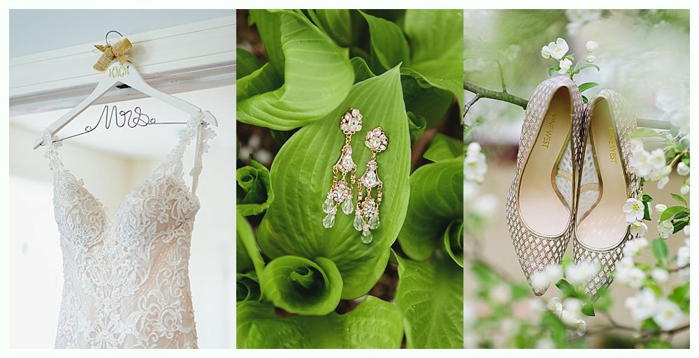 Wedding day details: gown on a hanger, earrings on leaves, shoes on a flowering branch.