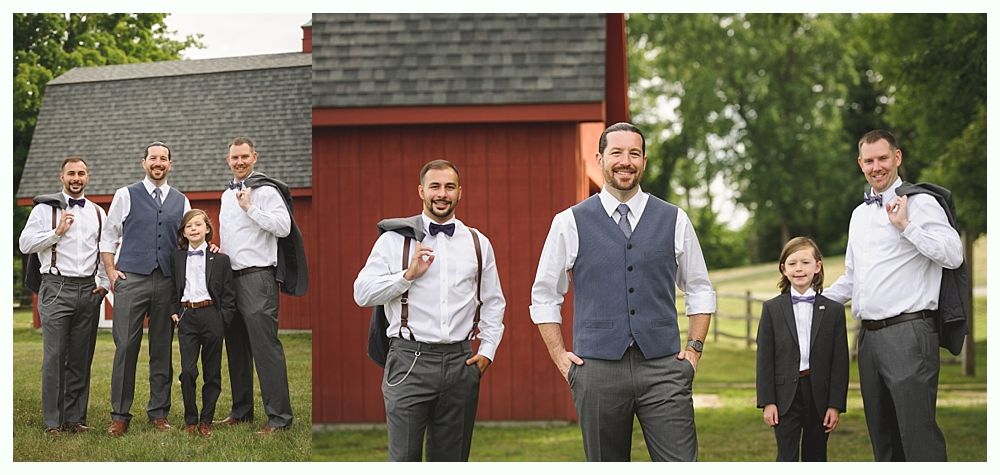 Groomsmen stand outside a red barn; they wear vests, bow ties, suspenders, and jackets draped over their shoulders.