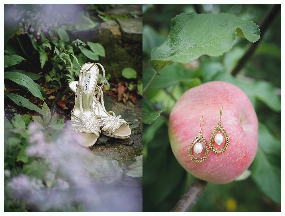 Wedding shoes near foliage and gold earrings on a red apple.