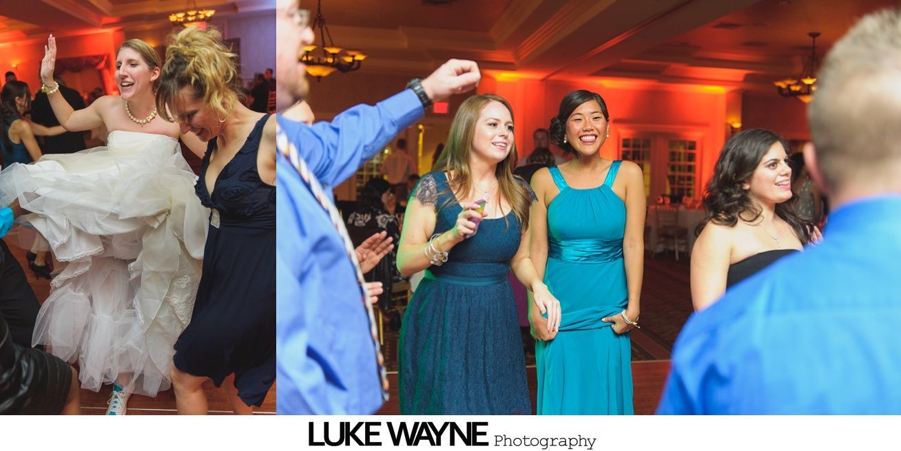 Wedding reception with dancing; bride in a white gown and guests in colorful dresses on a dance floor.