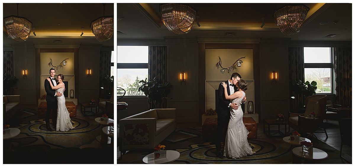 Wedding couple dancing in a dimly lit room, with crystal chandeliers and a neutral-toned décor.