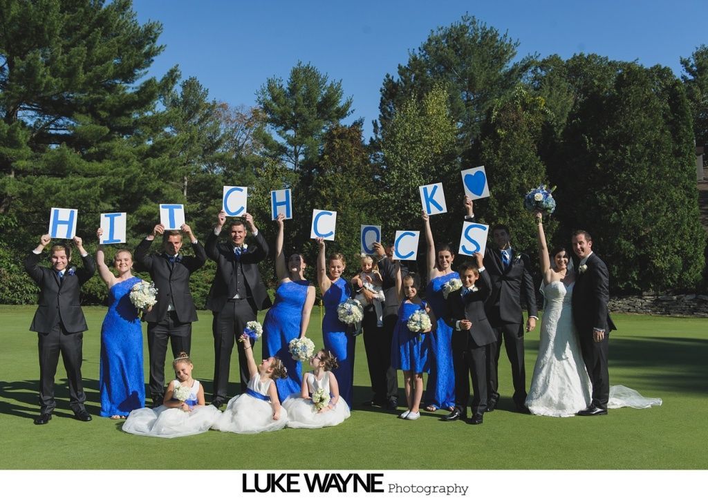 Wedding party holding signs spelling 