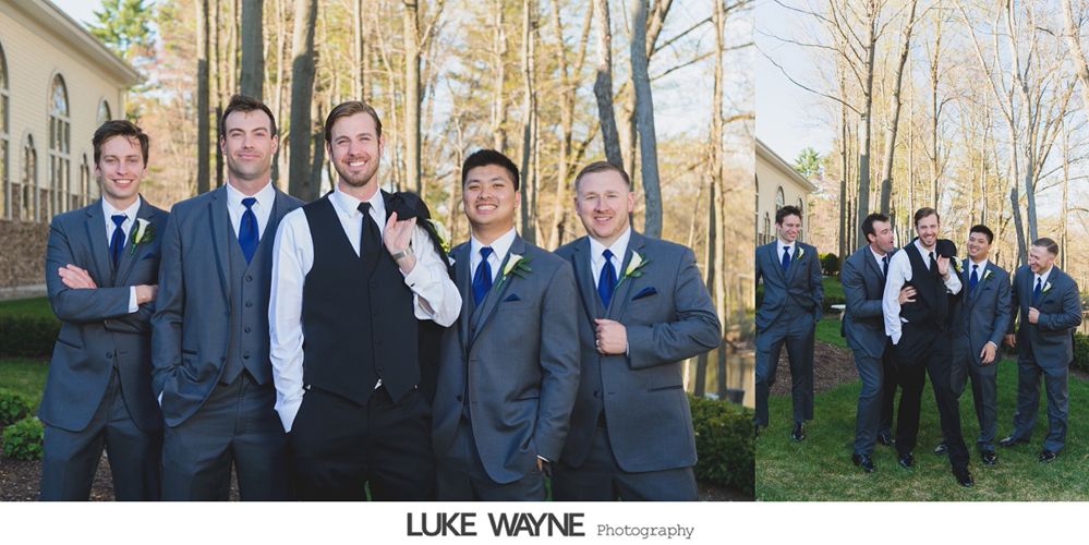 Groomsmen posing outdoors in gray suits with blue ties and white shirts, trees in the background.