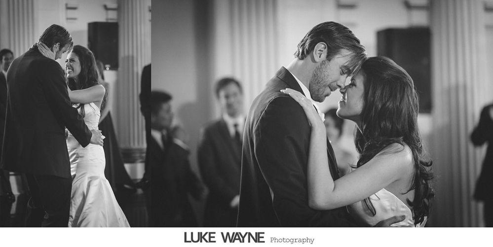 Couple dancing at a wedding reception, looking at each other intimately, in a black and white photo.