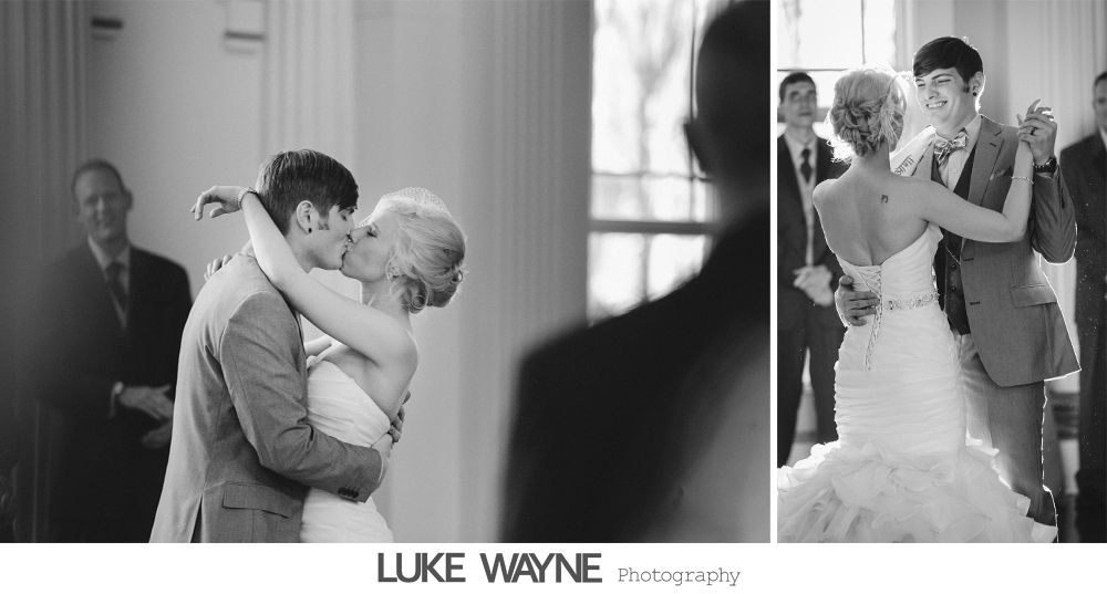 Bride and groom share a kiss and dance during a wedding. Black and white.