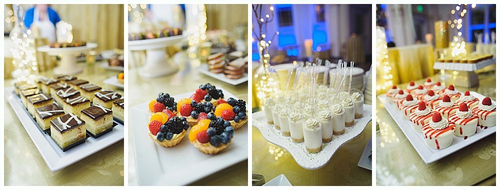 Dessert table with various sweets: tarts, squares, and small cakes.