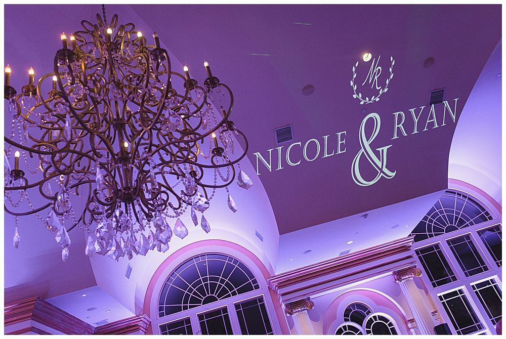 Elegant ballroom with chandelier and projected wedding names 