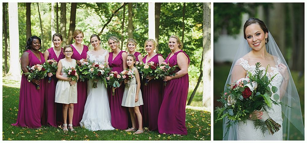 Wedding party in a forest setting. Bride in white dress with bridesmaids in magenta gowns, holding bouquets.