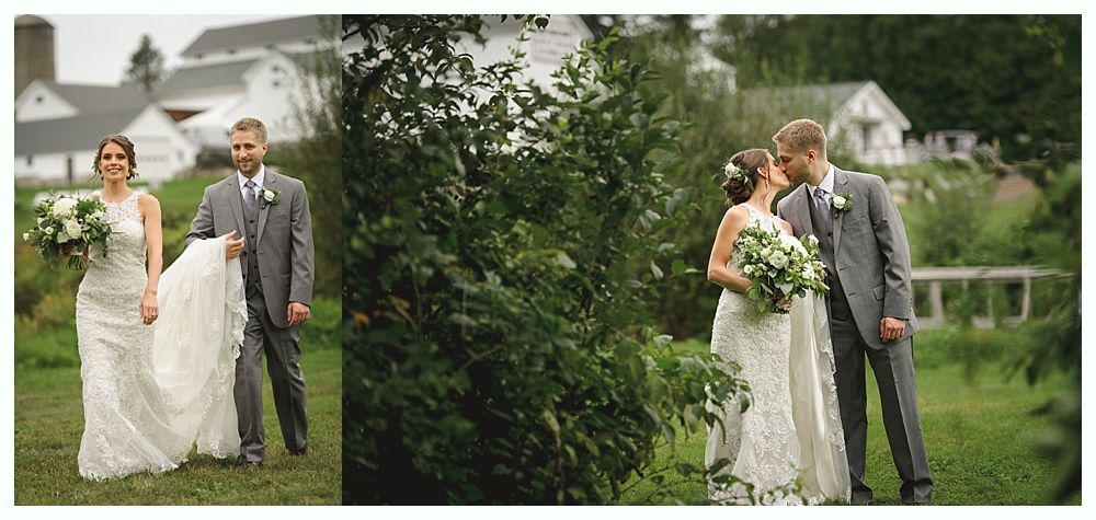 Wedding couple walking and kissing in a garden setting, white buildings in the background.