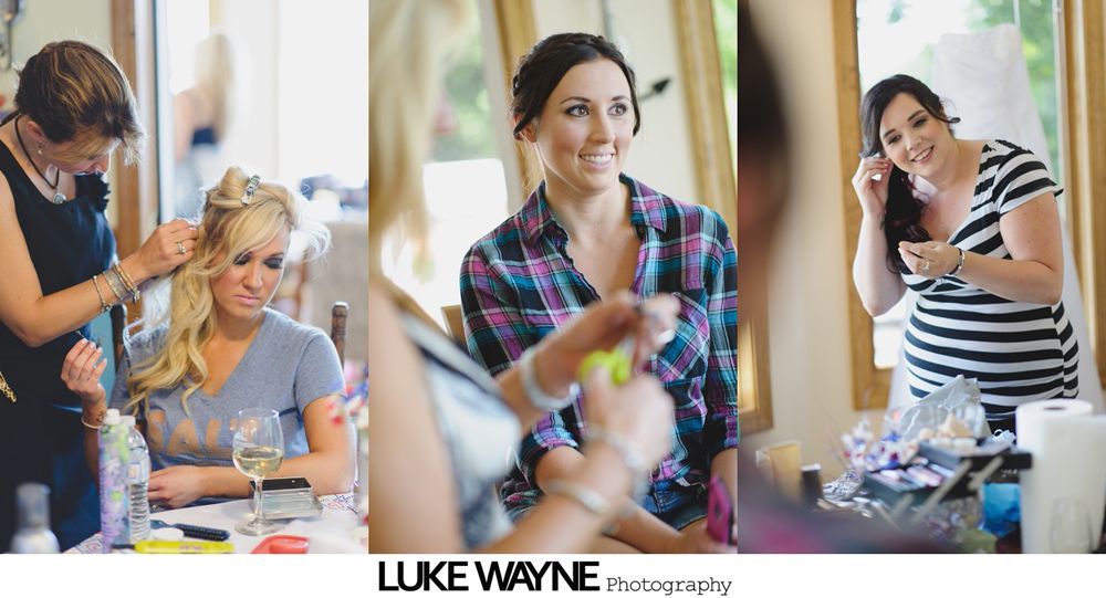 Women getting ready; hair and makeup. One smiles; others have hair styled or putting on jewelry. Bright room.