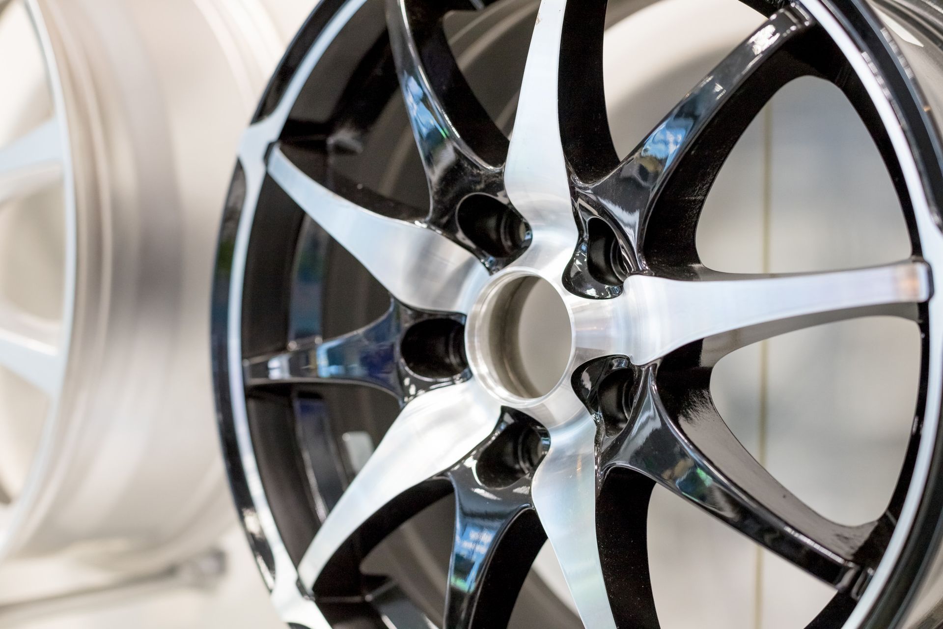 Shiny silver and black car alloy wheel.
