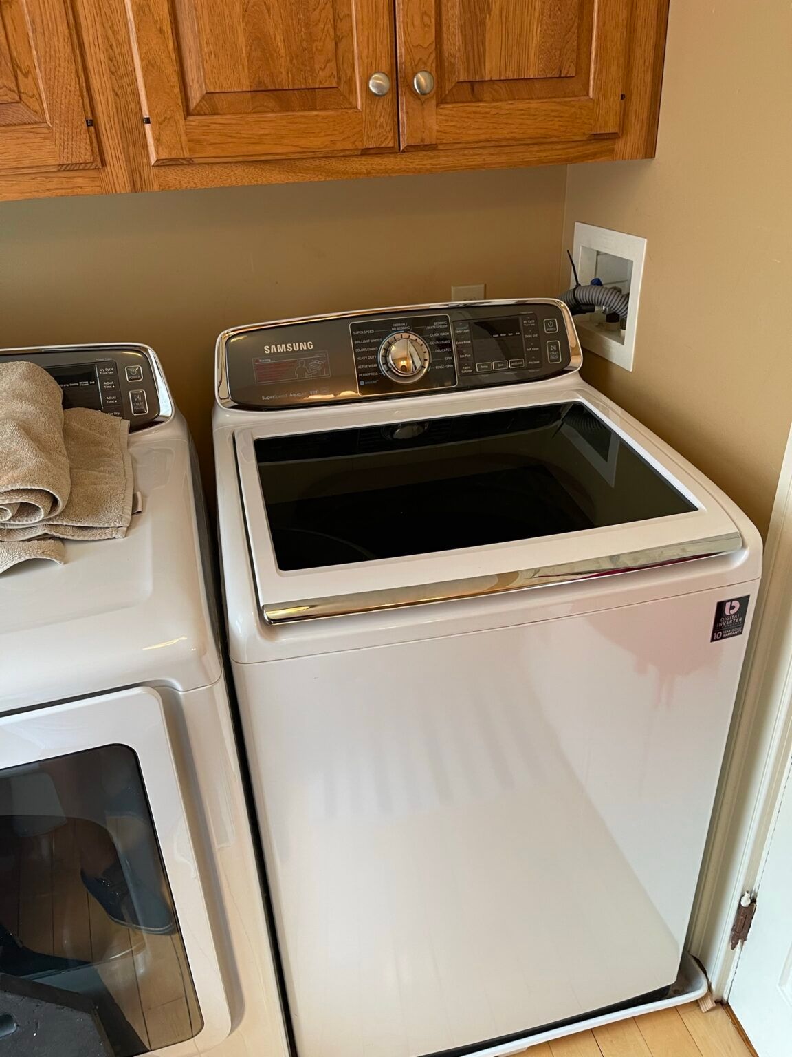 A white washer and dryer are sitting next to each other in a laundry room.