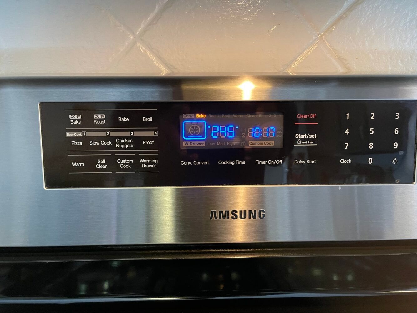 A stainless steel samsung oven with a digital display